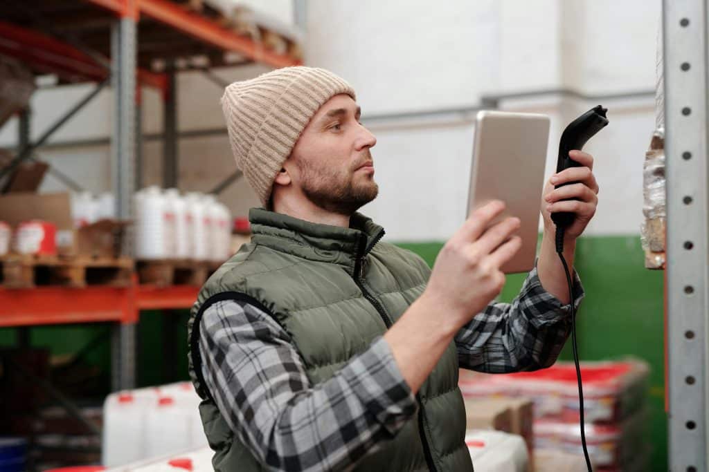 man scanning item at a warehouse