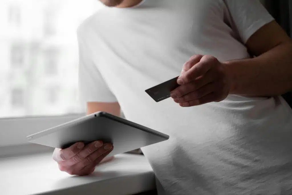 man on tablet with credit card